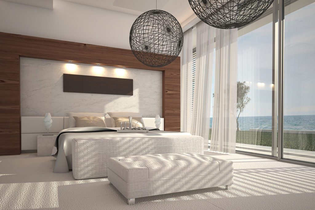 Modern bedroom with ocean view and decor.